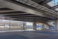 the underside of an overpass leading to a terminal terminal area with no cars or cars