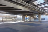 the underside of an overpass leading to a terminal terminal area with no cars or cars