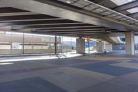 the underside of an overpass leading to a terminal terminal area with no cars or cars