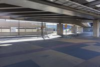 the underside of an overpass leading to a terminal terminal area with no cars or cars