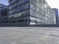 a building near a sidewalk with traffic next to it on the side of a road