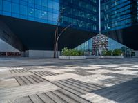 a white building next to a pool in a courtyard area with a walkway leading into it