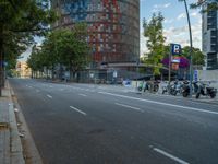 the empty road next to a building with many motorcycles on it and no people or vehicles in it