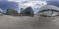 360 - vision photography of cars parked in a parking lot with the other two buildings behind them