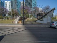 street in the city is full of tall buildings and cars going up and down the stairs