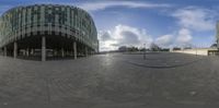 360 lens shot of empty public plaza in an urban area under a partly cloudy sky