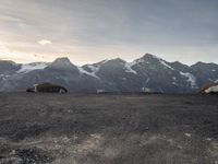 the mountain range is very barren, and the air contrails in the distance are visible