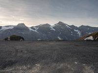 the mountain range is very barren, and the air contrails in the distance are visible