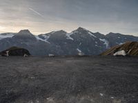 the mountain range is very barren, and the air contrails in the distance are visible