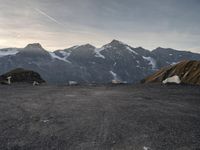 the mountain range is very barren, and the air contrails in the distance are visible