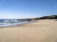 A Day at the Beach: Clear Sky, Ocean, and Horizon