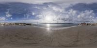 view of the ocean and a very large beach from an upside down fish eye lens