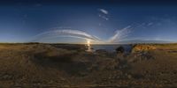 two people and their dog sitting at a beach watching a sunset with jets flying overhead