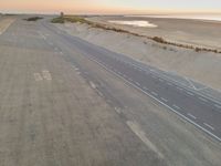 the beach road in the morning with some white markings painted on it's side