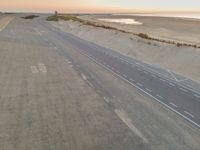 the beach road in the morning with some white markings painted on it's side