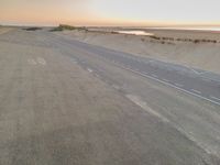 the beach road in the morning with some white markings painted on it's side