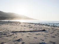 the sunlight shines brightly on a beach and the sand looks like it could have been washed down in time