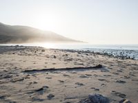 the sunlight shines brightly on a beach and the sand looks like it could have been washed down in time