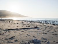 the sunlight shines brightly on a beach and the sand looks like it could have been washed down in time