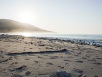 the sunlight shines brightly on a beach and the sand looks like it could have been washed down in time