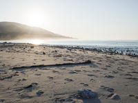 the sunlight shines brightly on a beach and the sand looks like it could have been washed down in time