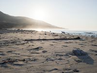 the sunlight shines brightly on a beach and the sand looks like it could have been washed down in time