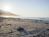 the sunlight shines brightly on a beach and the sand looks like it could have been washed down in time