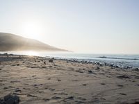 the sunlight shines brightly on a beach and the sand looks like it could have been washed down in time