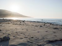 the sunlight shines brightly on a beach and the sand looks like it could have been washed down in time