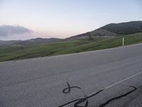 a bicycle is drawn onto the road with the help of chalk from a young rider