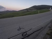 a bicycle is drawn onto the road with the help of chalk from a young rider