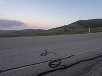 a bicycle is drawn onto the road with the help of chalk from a young rider