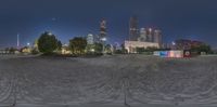 an old time looking panorama of a very beautiful park and city in the background at night