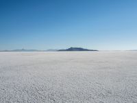 the snow - covered landscape looks beautiful and barren in its natural habitat, with no clouds