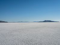 the snow - covered landscape looks beautiful and barren in its natural habitat, with no clouds