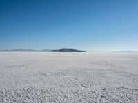 the snow - covered landscape looks beautiful and barren in its natural habitat, with no clouds