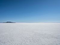 the snow - covered landscape looks beautiful and barren in its natural habitat, with no clouds