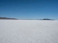 the snow - covered landscape looks beautiful and barren in its natural habitat, with no clouds