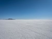 the snow - covered landscape looks beautiful and barren in its natural habitat, with no clouds