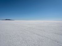 the snow - covered landscape looks beautiful and barren in its natural habitat, with no clouds