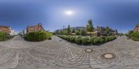 a 360 - view lens image shows a beautiful town with beautiful cobblestones and trees