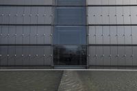 a person on a skateboard in front of a big building with a curved roof