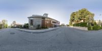 a street view with a house and car in the background as seen from a fish eye lens