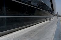 a picture of a bench in front of a very big building at an outdoor area
