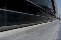 a picture of a bench in front of a very big building at an outdoor area