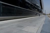 a picture of a bench in front of a very big building at an outdoor area