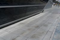 a picture of a bench in front of a very big building at an outdoor area