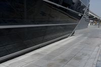 a picture of a bench in front of a very big building at an outdoor area