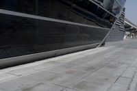 a picture of a bench in front of a very big building at an outdoor area