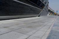 a picture of a bench in front of a very big building at an outdoor area